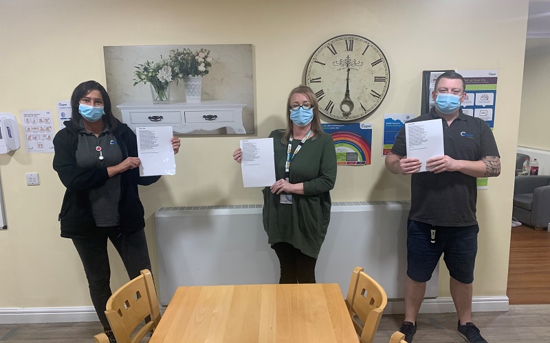 Staff members at Cygnet Aspen Clinic holding a copy of the poem