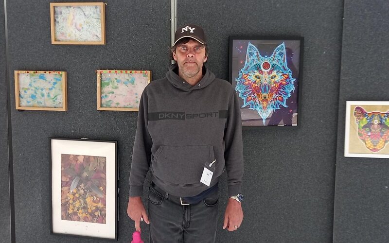 Mark at the exhibition of his artwork