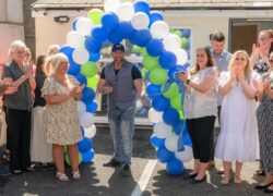 Actor Ross O'Hennessy cutting the ribbon to open Ty Alarch