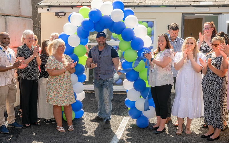 Actor Ross O'Hennessy cutting the ribbon to open Ty Alarch