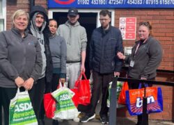 Service users and staff delivering their donations to the foodbank