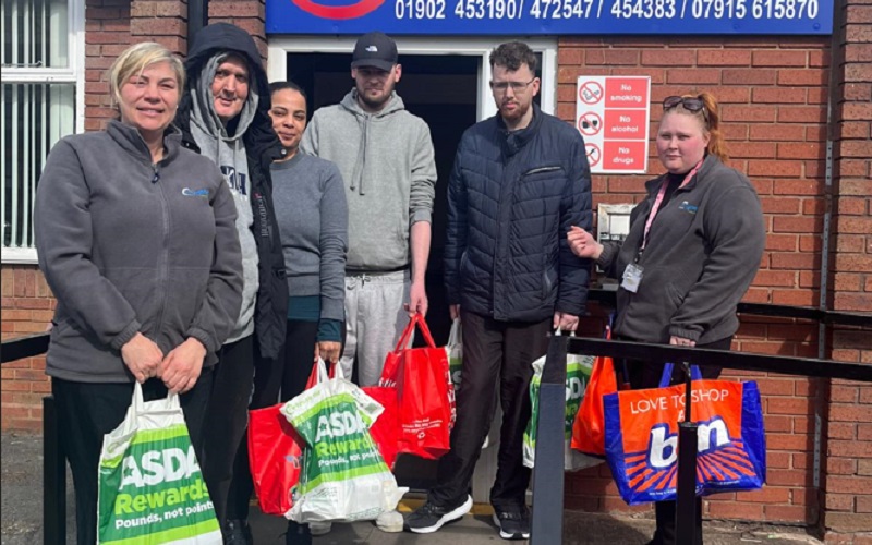 Service users and staff delivering their donations to the foodbank