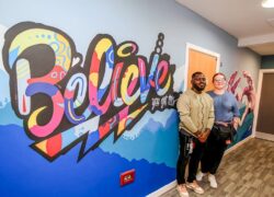 Support worker and muralist Wumi (Dare) Aduloju with Unicorn Ward Manager Vicky Higgins-Kay in front of the mural