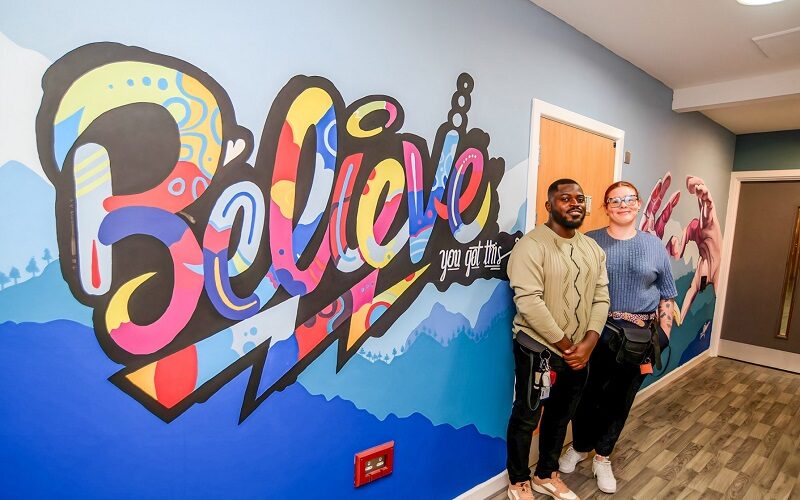 Support worker and muralist Wumi (Dare) Aduloju with Unicorn Ward Manager Vicky Higgins-Kay in front of the mural