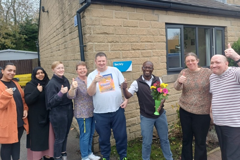 Beckly staff and some of the people they support celebrating their CQC rating