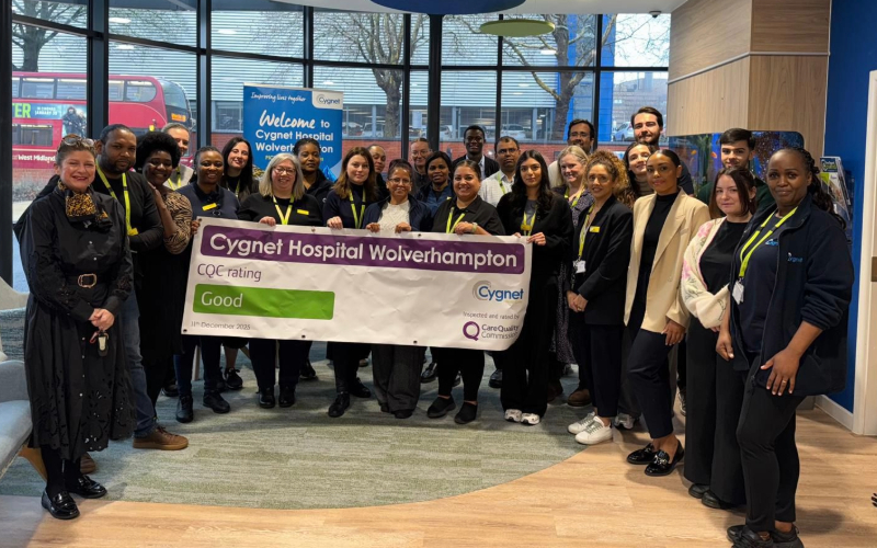 A group of healthcare staff standing together indoors at Cygnet Hospital Wolverhampton, holding a banner that reads “Cygnet Hospital Wolverhampton – CQC rating: Good,” celebrating the hospital’s inspection outcome.