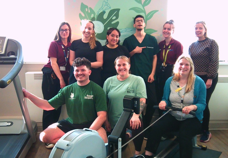 The team in the gym at Cygnet Hospital Kewstoke during a Comic Relief fundraising event, with one person seated on the rowing machine, pulling the handle.