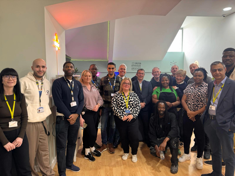 The team at Cygnet Hospital Stevenage involved in creating the social hub smiling in the renovated space