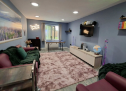 Modern social hub with sofas, games, TV and soft lighting at Cygnet Kenney House.