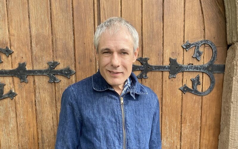 Michael by the entrance to All Saints Church in Blakeney