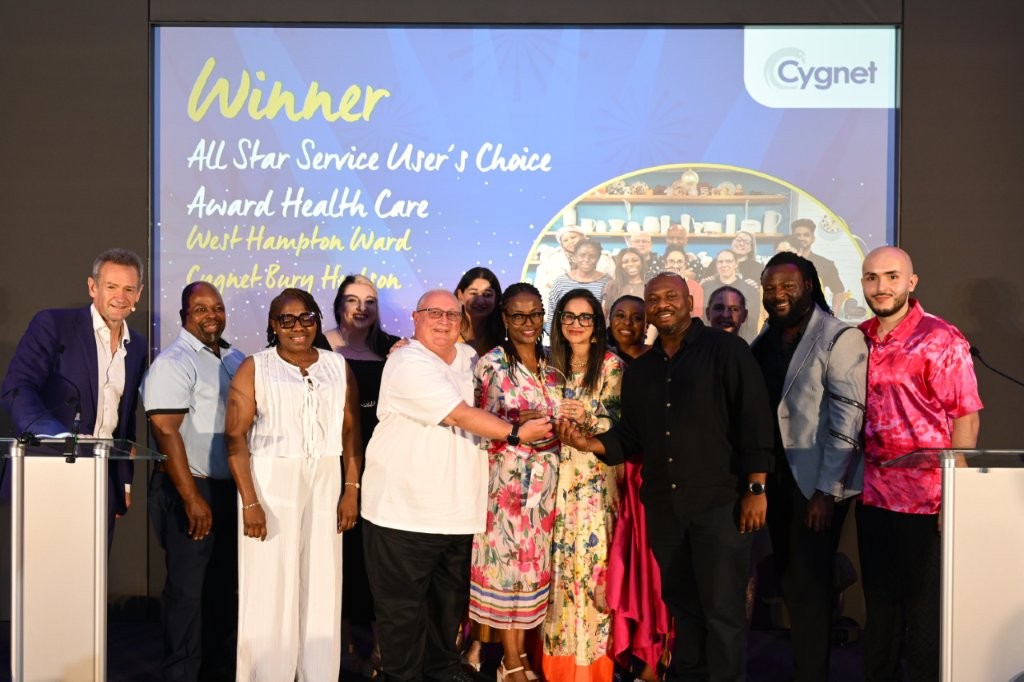 The winners of the All Star Service User’s Choice Award on stage with Head of Coproduction and Lived Experience Raf Hamaizia and celebrity host Alexander Armstrong