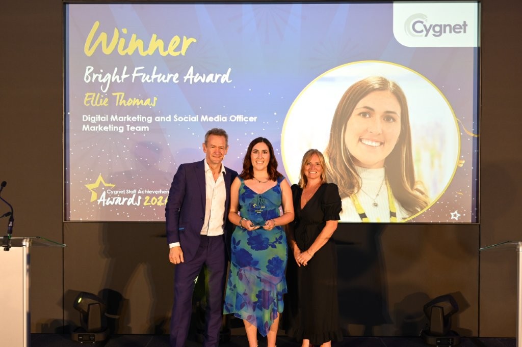 The winner of the Bright Future Award on stage with Head of HR Jenny Gibson and celebrity host Alexander Armstrong