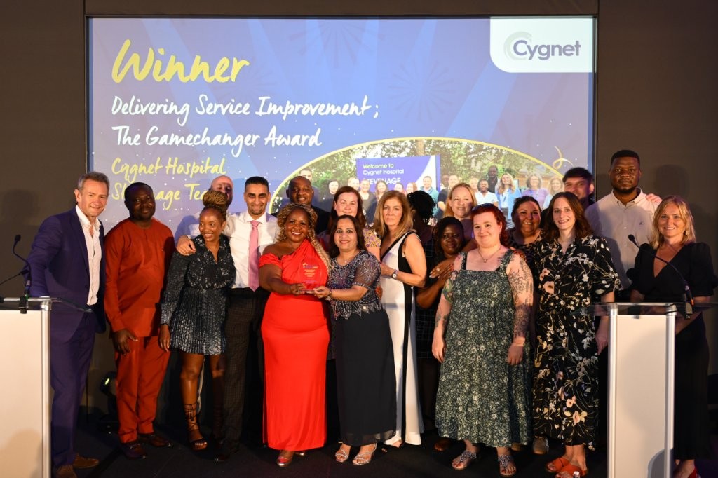 The winners of the Delivering Service Improvement; The Gamechanger Award on stage with Head of HR Jenny Gibson and celebrity host Alexander Armstrong
