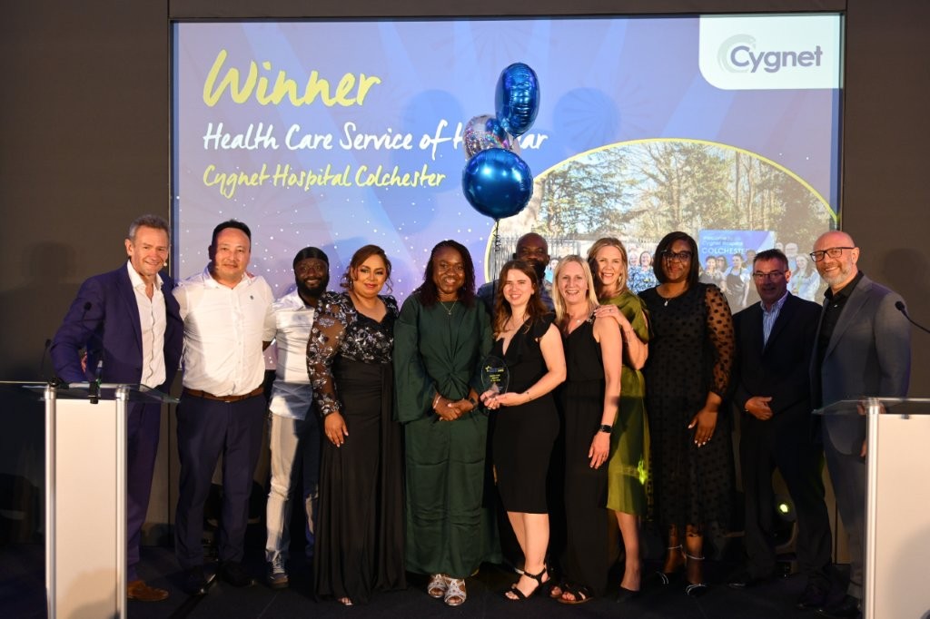 The winners of the Health Care Service of the Year on stage with Interim Group Medical Director Salim Matta and celebrity host Alexander Armstrong