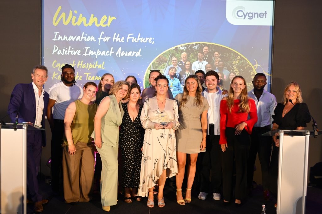 The winners of the Innovation for the Future; Positive Impact Award on stage with Head of HR Jenny Gibson and celebrity host Alexander Armstrong