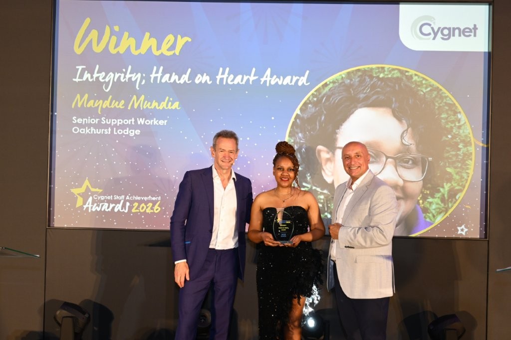 The winner of the Integrity; Hand on Heart Award on stage with CEO Tony Romero and celebrity host Alexander Armstrong