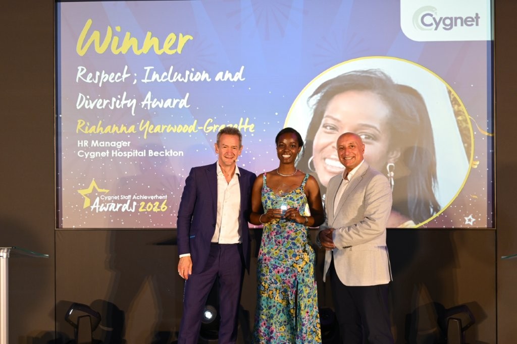 The winner of the Respect; Inclusion and Diversity Award on stage with CEO Tony Romero and celebrity host Alexander Armstrong