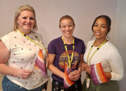 Members of the team at Cygnet Elowen Hospital after the glitter contest holding the orange, white, and purple Lesbian Pride Flag