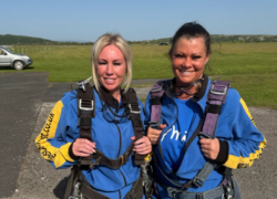 Two members of Cygnet Social Care's North West Supported Living team in their jumpsuits before the skydive