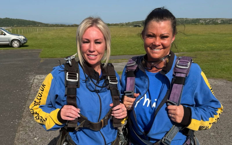 Two members of Cygnet Social Care's North West Supported Living team in their jumpsuits before the skydive
