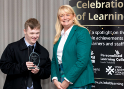 Hope House resident William posing at the awards with a member of the college team on stage