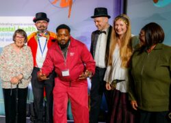 Akin on the stage at National Lived Experience Awards